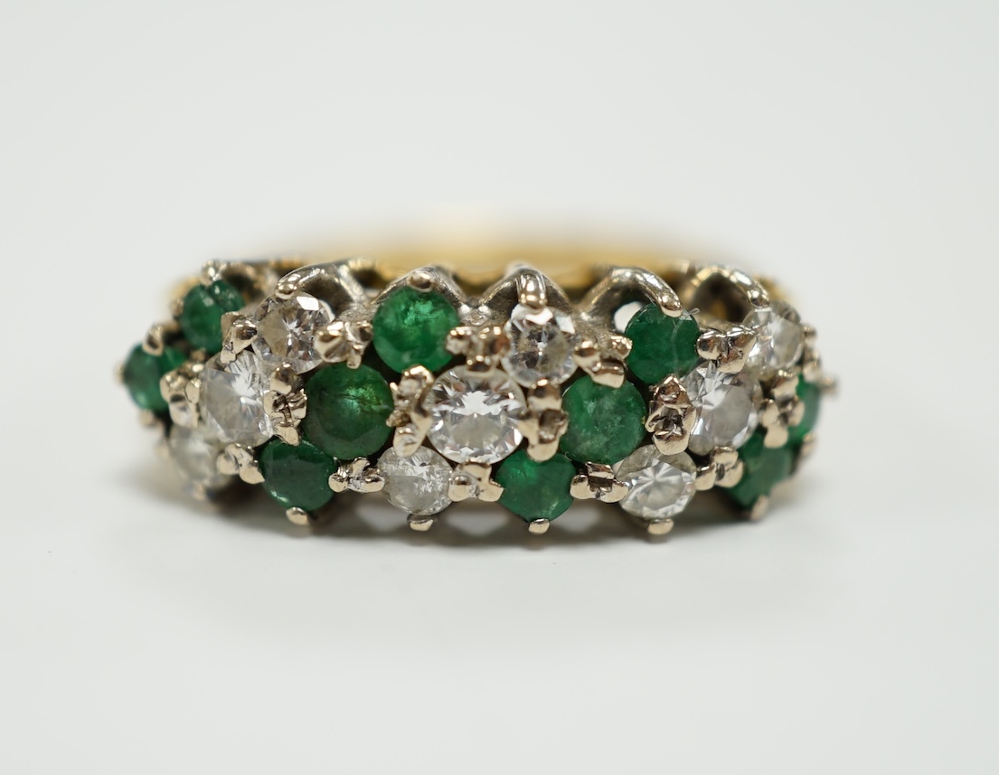 A modern 18ct, emerald and diamond set cluster half hoop ring, size O, gross weight 4.9 grams.